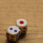 two dices sitting on top of a wooden table